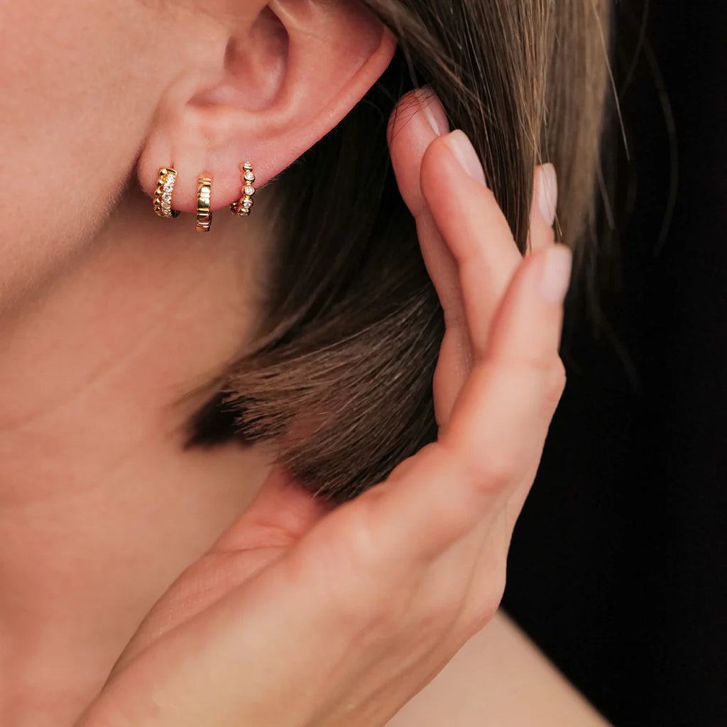 Tiia White Diamond Huggies in Yellow Gold